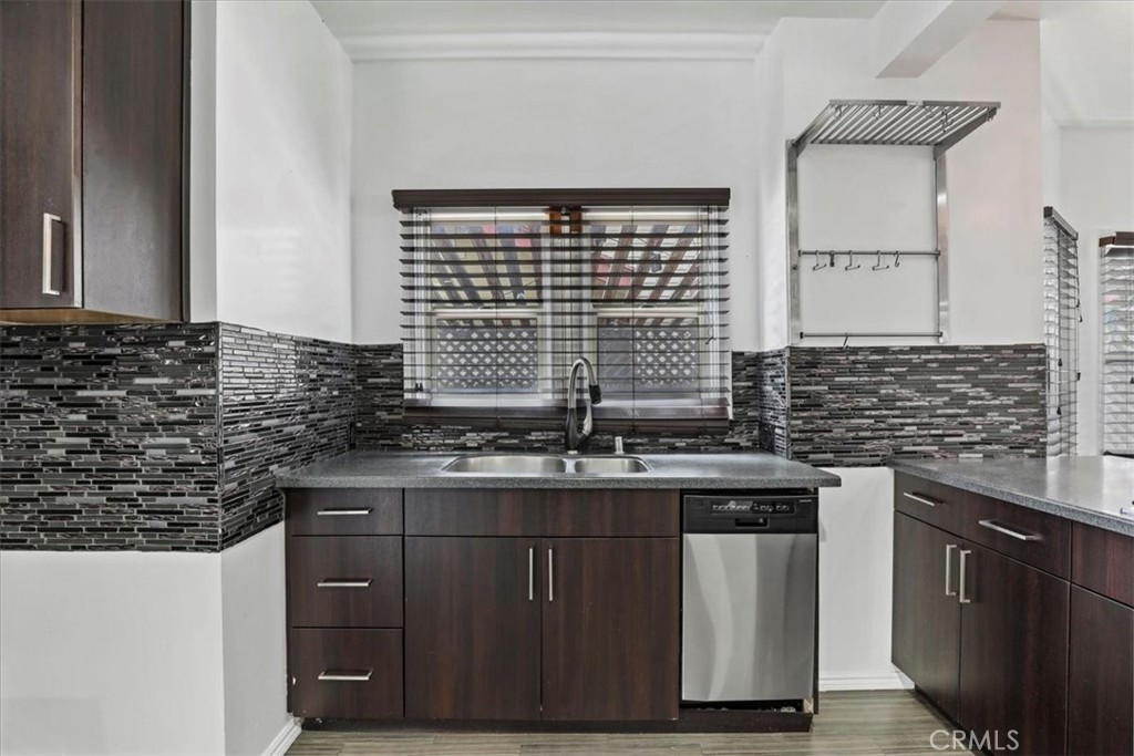 1352 Elm Avenue Long Beach, CA 90813 - Photo 22 of 71 a kitchen with stainless steel appliances granite countertop a sink stove and cabinets