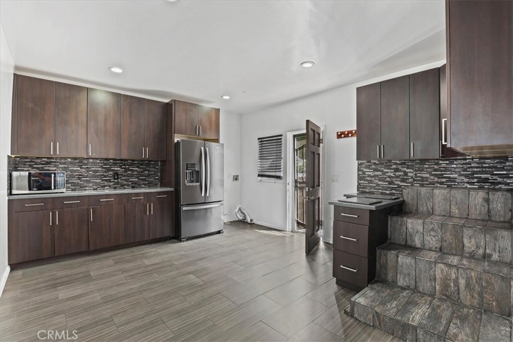 1352 Elm Avenue Long Beach, CA 90813 - Photo 26 of 71 a kitchen with stainless steel appliances a refrigerator and a stove top oven