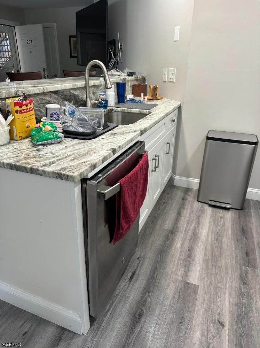 88 Boulevard, Unit 207 Passaic, NJ 07055 - Photo 4 of 13 a kitchen with stainless steel appliances granite countertop a sink stove and cabinets