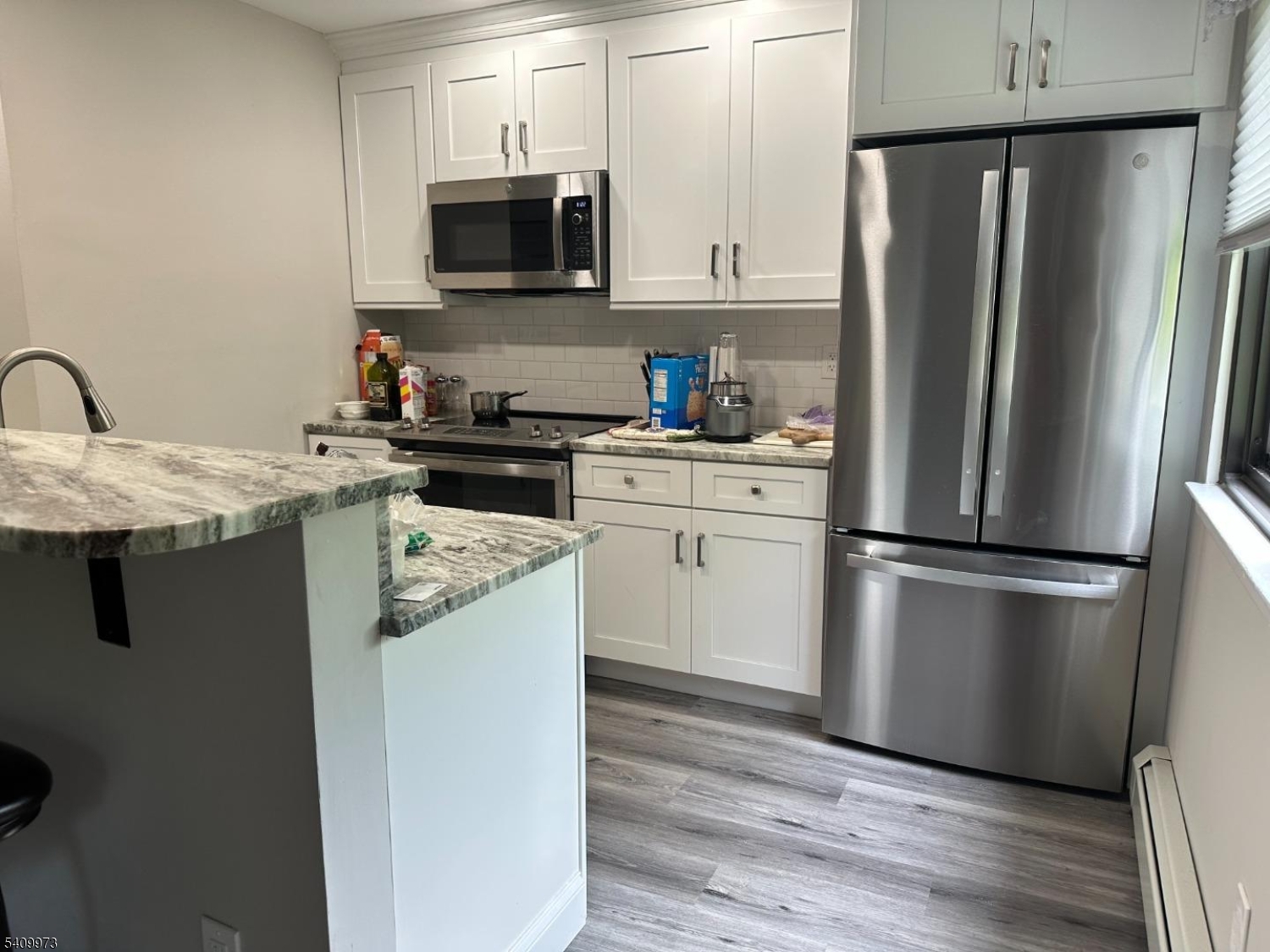 88 Boulevard, Unit 207 Passaic, NJ 07055 - Photo 5 of 13 a kitchen with a refrigerator sink and microwave
