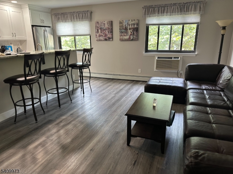 88 Boulevard, Unit 207 Passaic, NJ 07055 - Photo 6 of 13 a view of a workspace with furniture and a window