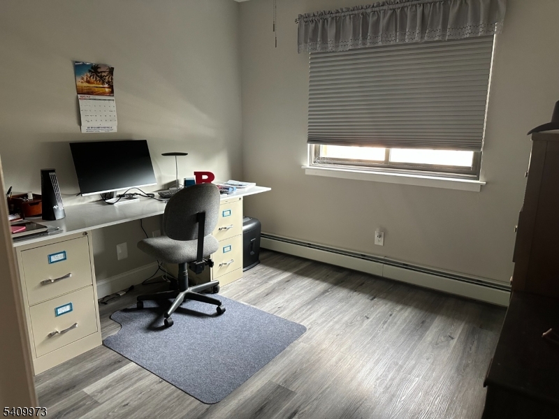 88 Boulevard, Unit 207 Passaic, NJ 07055 - Photo 7 of 13 a view of a workspace with furniture and a window
