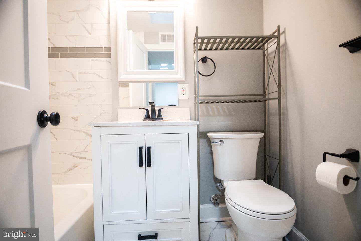 138 Dale Street Alexandria, VA 22305 - Photo 34 of 44 a bathroom with a toilet sink and mirror