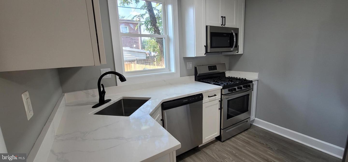 138 Dale Street Alexandria, VA 22305 - Photo 9 of 44 a kitchen with stainless steel appliances a stove microwave and sink