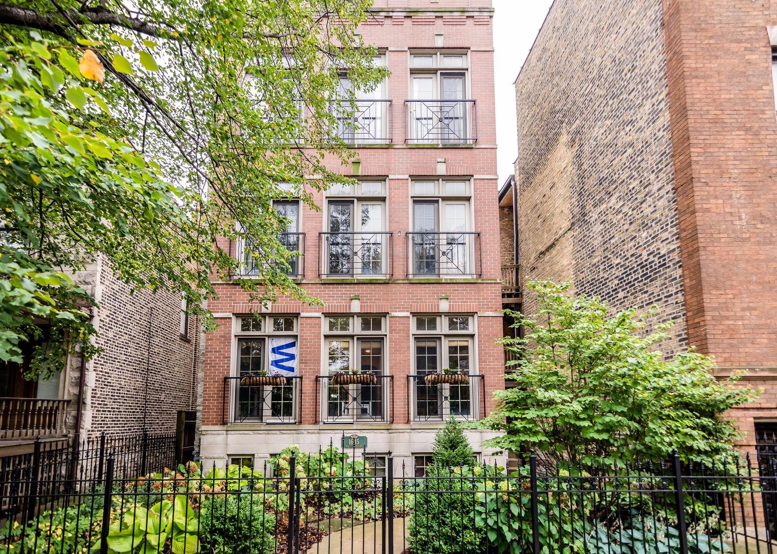 1645 West Addison Street, Unit 2 Chicago, IL 60613 - Photo 1 of 19 front view of a building with a garden view