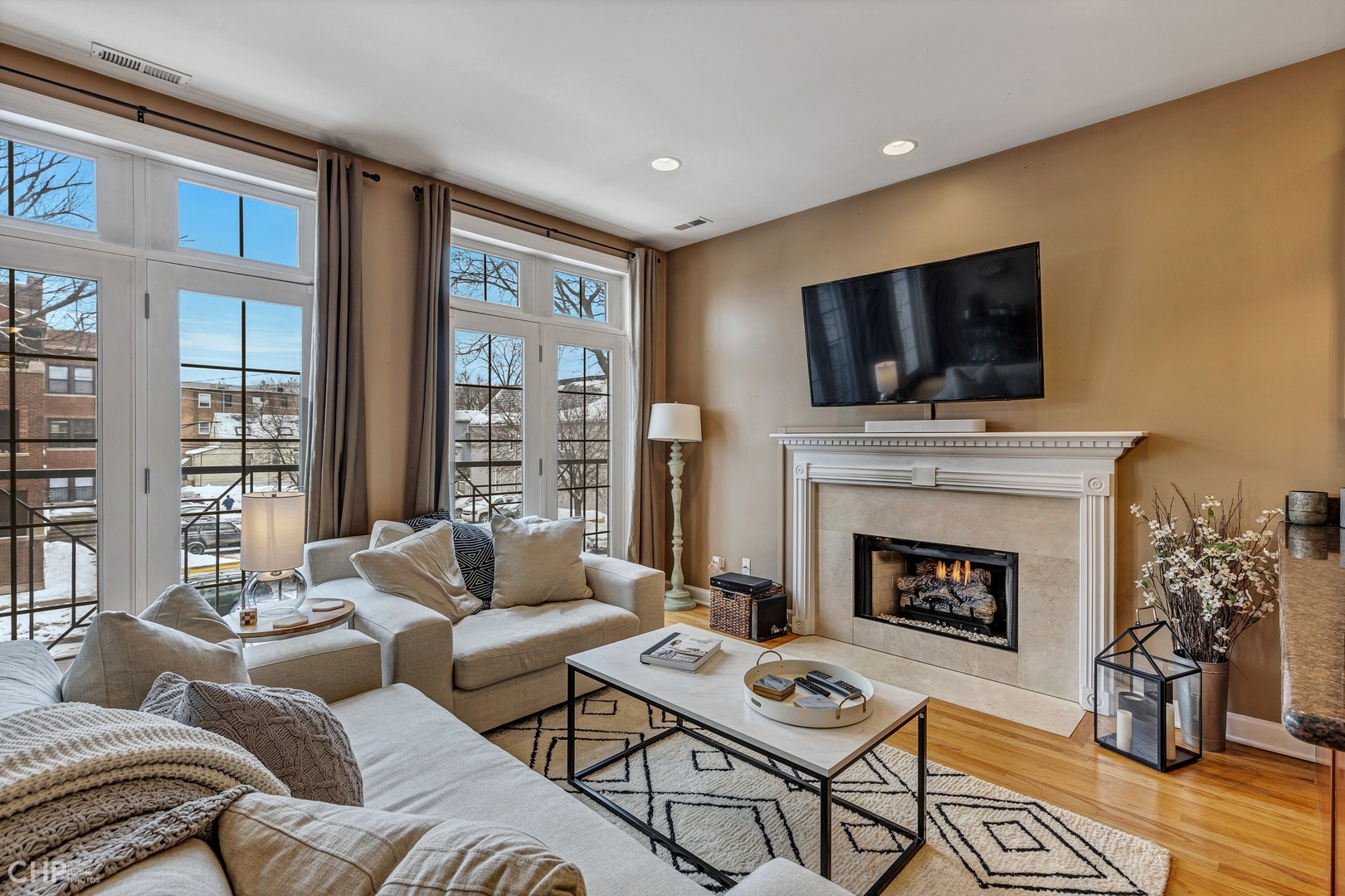 1645 West Addison Street, Unit 2 Chicago, IL 60613 - Photo 2 of 19 a living room with furniture a flat screen tv and a fireplace