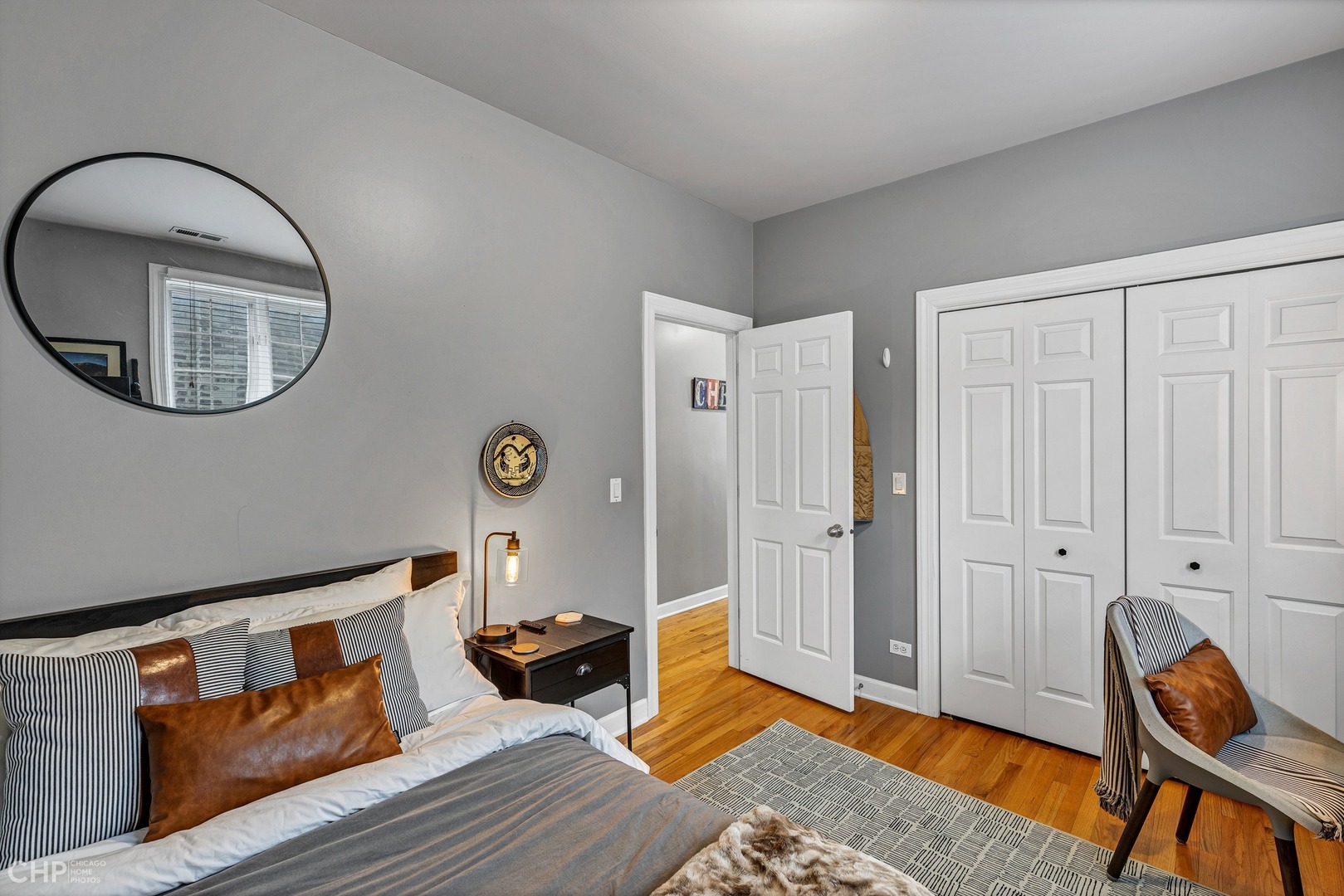 1645 West Addison Street, Unit 2 Chicago, IL 60613 - Photo 14 of 19 a living room with furniture a rug a lamp and wooden floor
