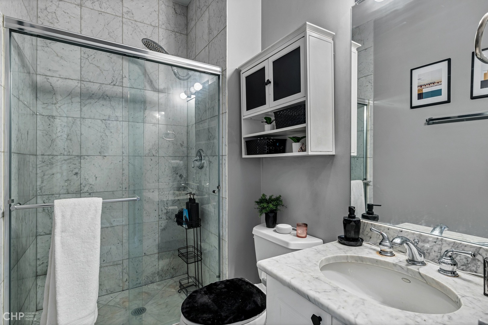 1645 West Addison Street, Unit 2 Chicago, IL 60613 - Photo 15 of 19 a bathroom with a sink and a shower