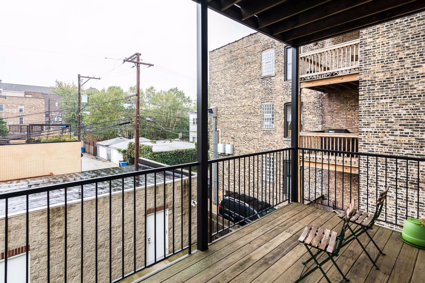 1645 West Addison Street, Unit 2 Chicago, IL 60613 - Photo 17 of 19 a view of a balcony with wooden floor