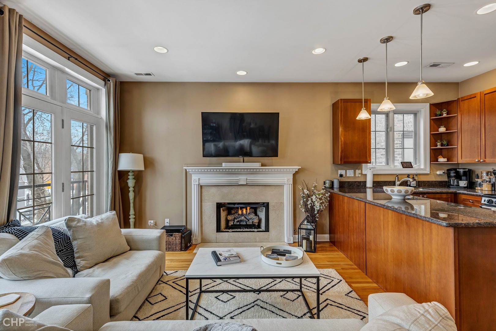 1645 West Addison Street, Unit 2 Chicago, IL 60613 - Photo 3 of 19 a living room with furniture a flat screen tv and a fireplace