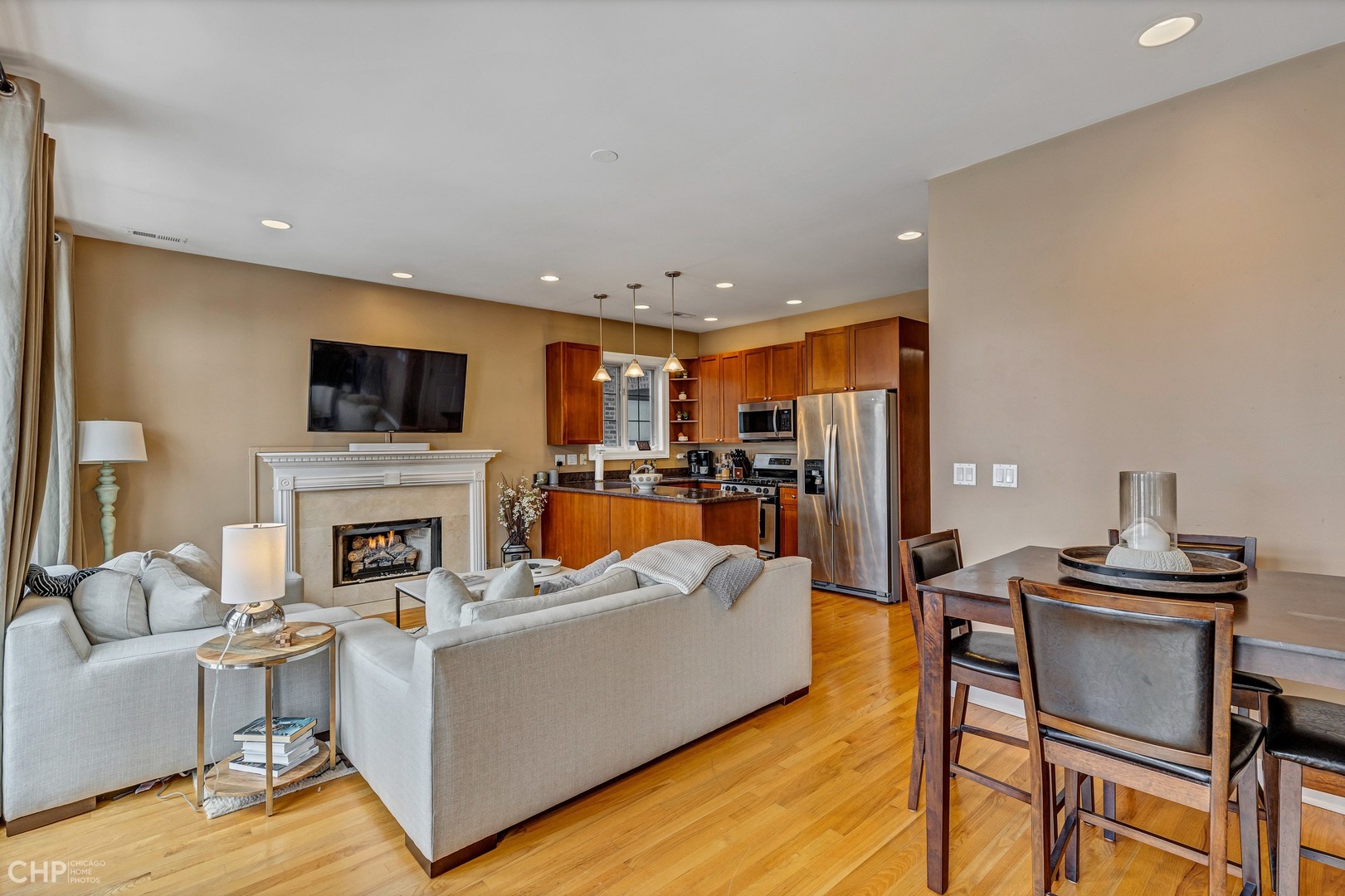 1645 West Addison Street, Unit 2 Chicago, IL 60613 - Photo 4 of 19 a living room with furniture a fireplace and a flat screen tv