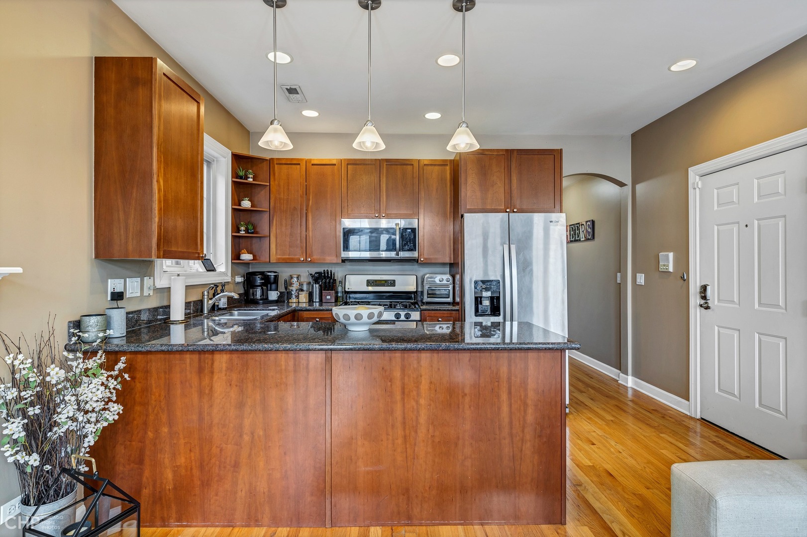 1645 West Addison Street, Unit 2 Chicago, IL 60613 - Photo 5 of 19 a kitchen with stainless steel appliances granite countertop a refrigerator a sink and a stove