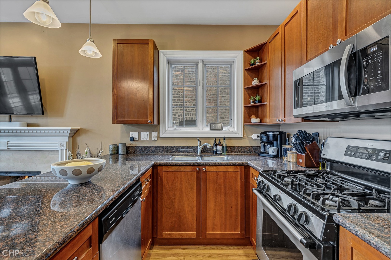 1645 West Addison Street, Unit 2 Chicago, IL 60613 - Photo 7 of 19 a kitchen with granite countertop a sink stove and cabinets