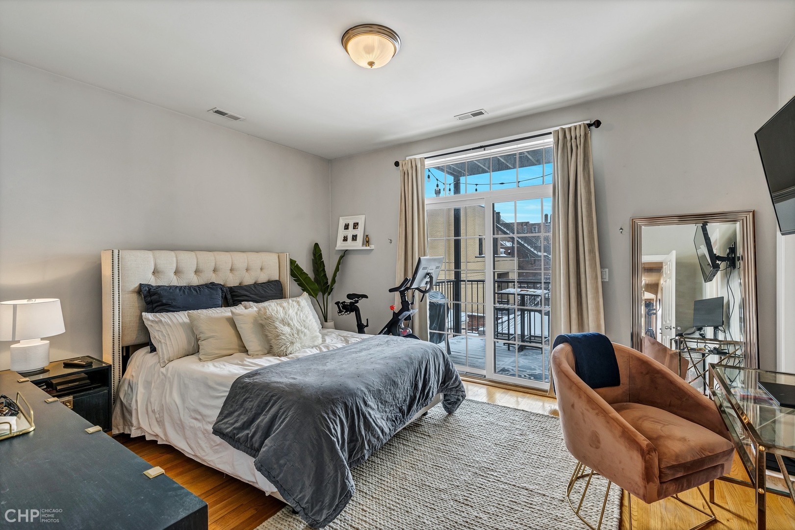 1645 West Addison Street, Unit 2 Chicago, IL 60613 - Photo 8 of 19 a bedroom with a bed and glass top table