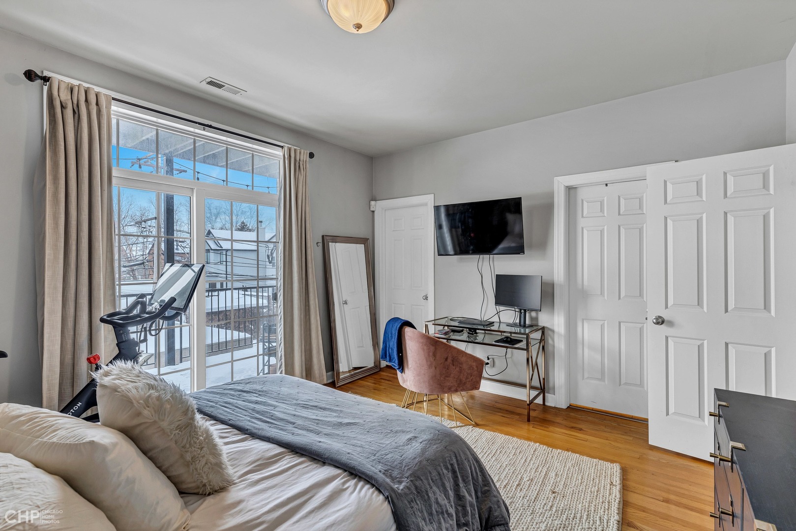 1645 West Addison Street, Unit 2 Chicago, IL 60613 - Photo 9 of 19 a bedroom with a bed and a flat screen tv