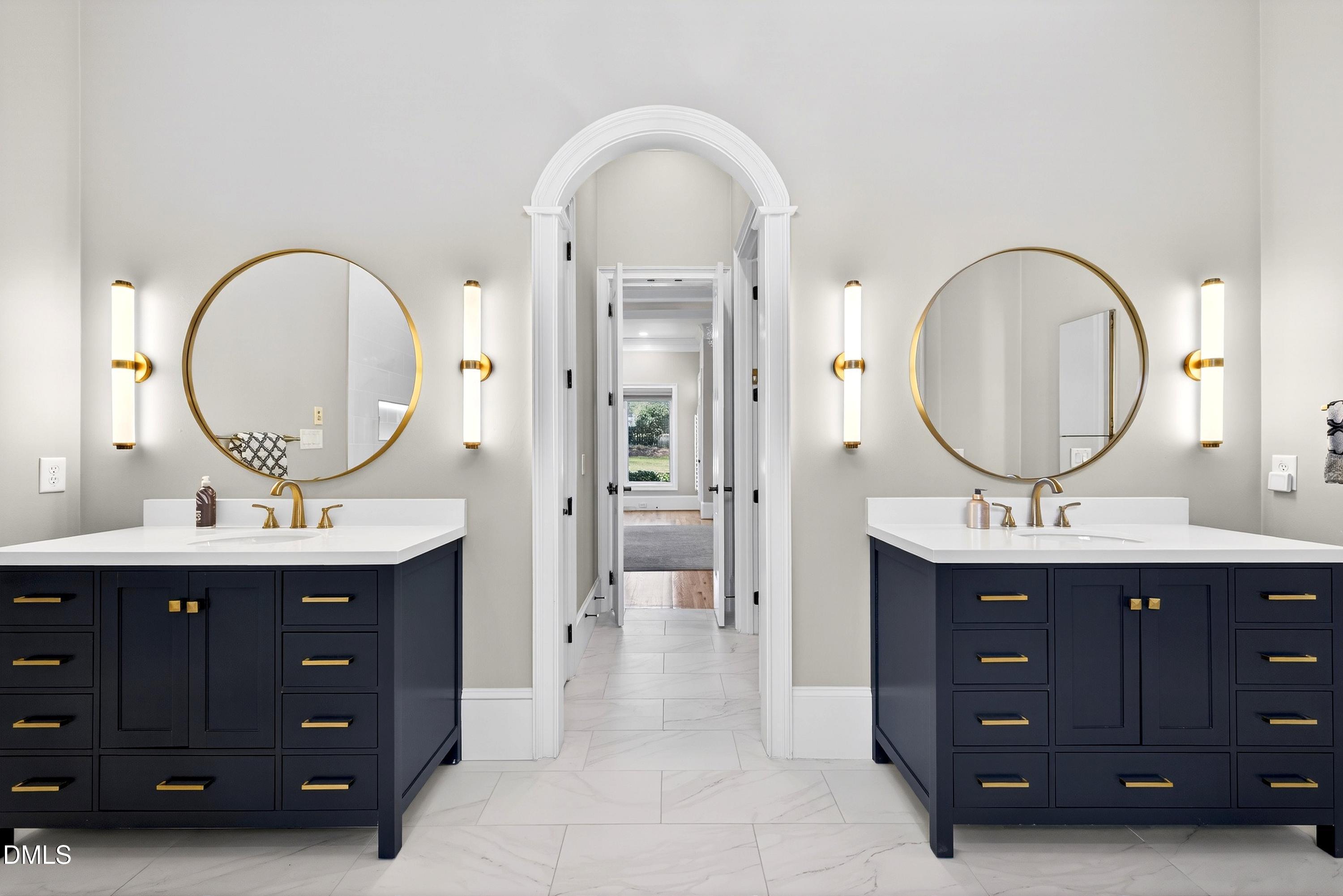 6701 Foxfire Place Raleigh, NC 27615 - Photo 27 of 67 a bathroom with a double vanity sink and a mirror