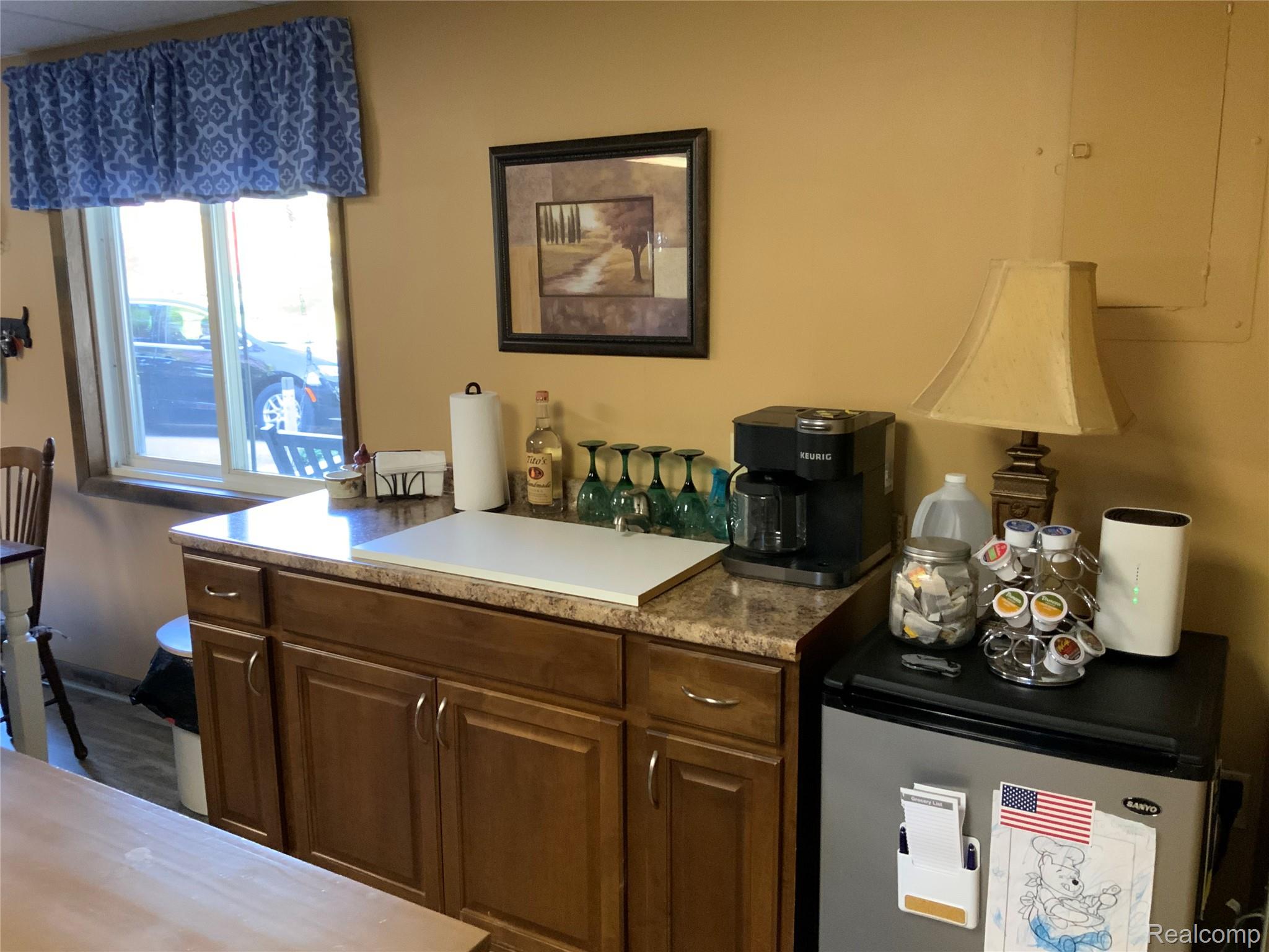 3828 Morgan Road Lake Orion, MI 48359 - Photo 18 of 39 Built-in cabinetry with wood-finish doors and drawers, laminate countertop, and single-pane window
