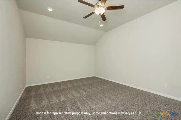 an empty room with a ceiling fan and a window