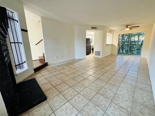 a kitchen with a refrigerator and a sink