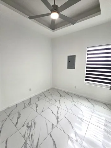 a view of a livingroom with a ceiling fan and window