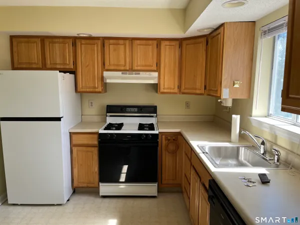 a kitchen with a sink stove and cabinets