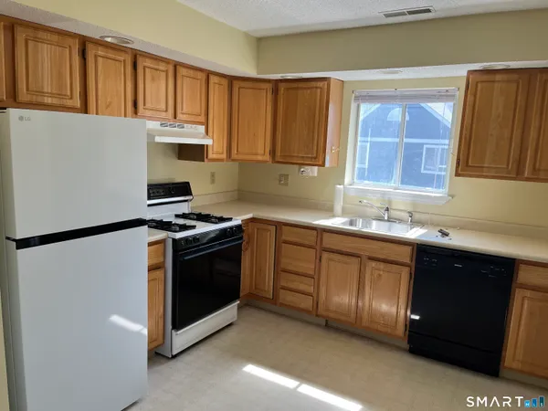 a kitchen with stainless steel appliances granite countertop a refrigerator sink and cabinets