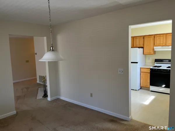 a view of empty room with a fireplace and fan