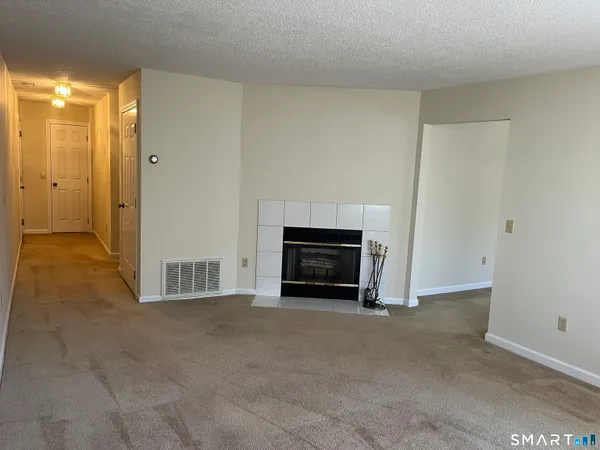 a view of empty room with a fireplace