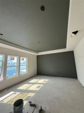 a large kitchen with kitchen island a large counter top a sink stainless steel appliances and cabinets