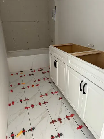 a dining room with stainless steel appliances kitchen island granite countertop a dining table chairs and a refrigerator