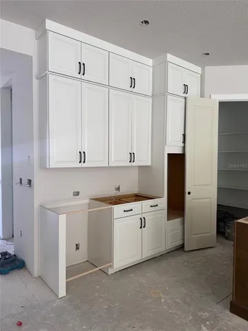 a large kitchen with a large window and stainless steel appliances