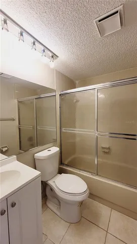 a bathroom with a toilet a sink and shower