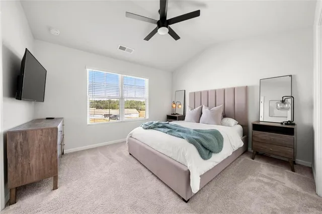 a bed room with a bed and a television