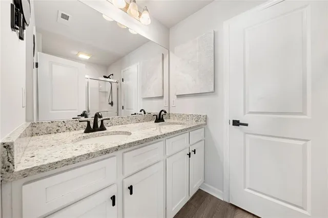 a bathroom with a granite countertop sink and a mirror