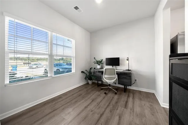 a living room with furniture wooden floor and a flat screen tv