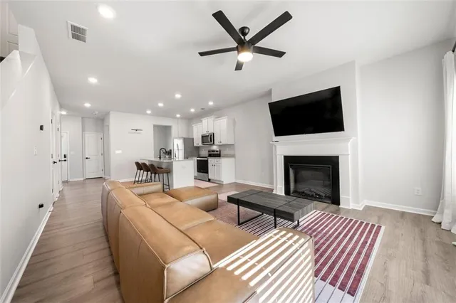 a living room with furniture a fireplace and a flat screen tv