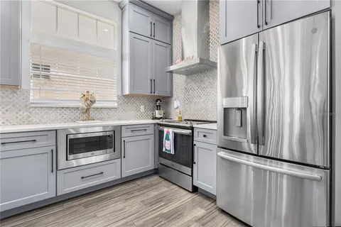 a kitchen with stainless steel appliances white cabinets and white appliances