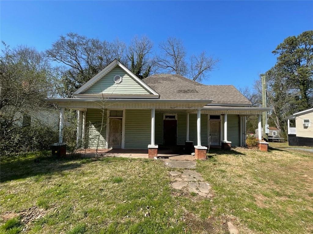 a front view of a house with a garden