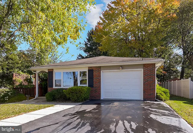 a front view of house with yard and trees