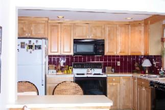 Undisclosed Address Centerville, MA 02632 - Photo 3 of 9 a kitchen with stainless steel appliances wooden cabinets and a stove top oven