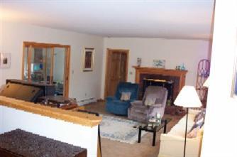 Undisclosed Address Centerville, MA 02632 - Photo 5 of 9 a living room with furniture and a fireplace