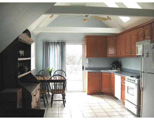 21 Reed Street Marshfield, MA 02020 - Photo 11 of 19 a kitchen with stainless steel appliances granite countertop a stove a sink and a microwave