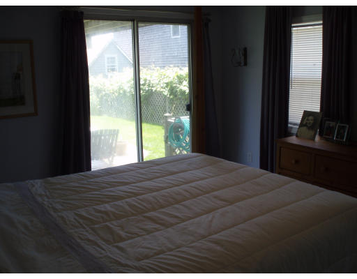 21 Reed Street Marshfield, MA 02020 - Photo 3 of 19 a bedroom with a bed and a flat tv screen next to a window