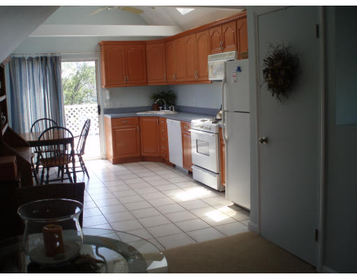 21 Reed Street Marshfield, MA 02020 - Photo 10 of 19 a kitchen with granite countertop a stove a refrigerator and a dining table