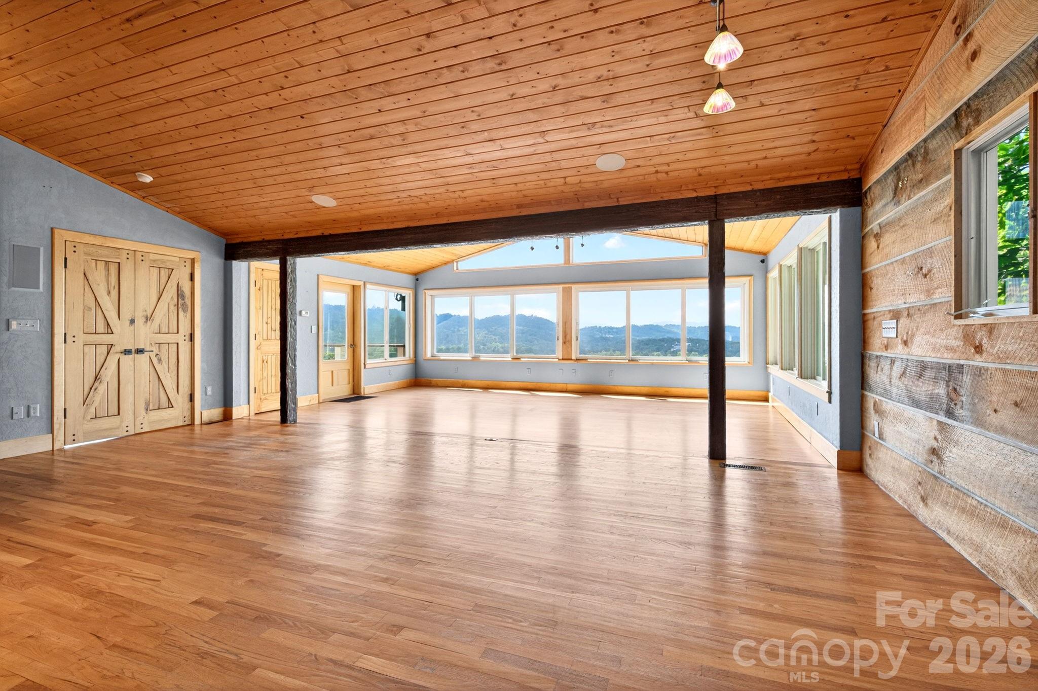 38 Lookout Road Asheville, NC 28804 - Photo 14 of 34 a view of an empty room with wooden floor and a window