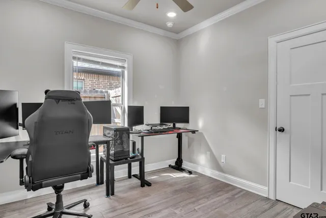 a view of a workspace with furniture and a window