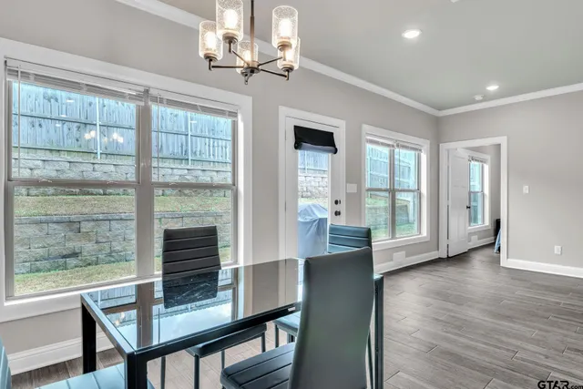 a view of a livingroom with furniture wooden floor and a chandelier