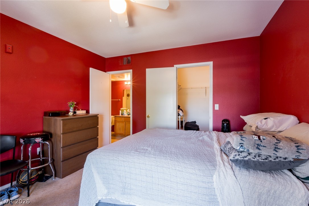 7255 West Sunset Road, Unit 2030 Las Vegas, NV 89113 - Photo 13 of 24 Bedroom with a spacious closet, carpet floors, a ceiling fan, and ensuite bathroom