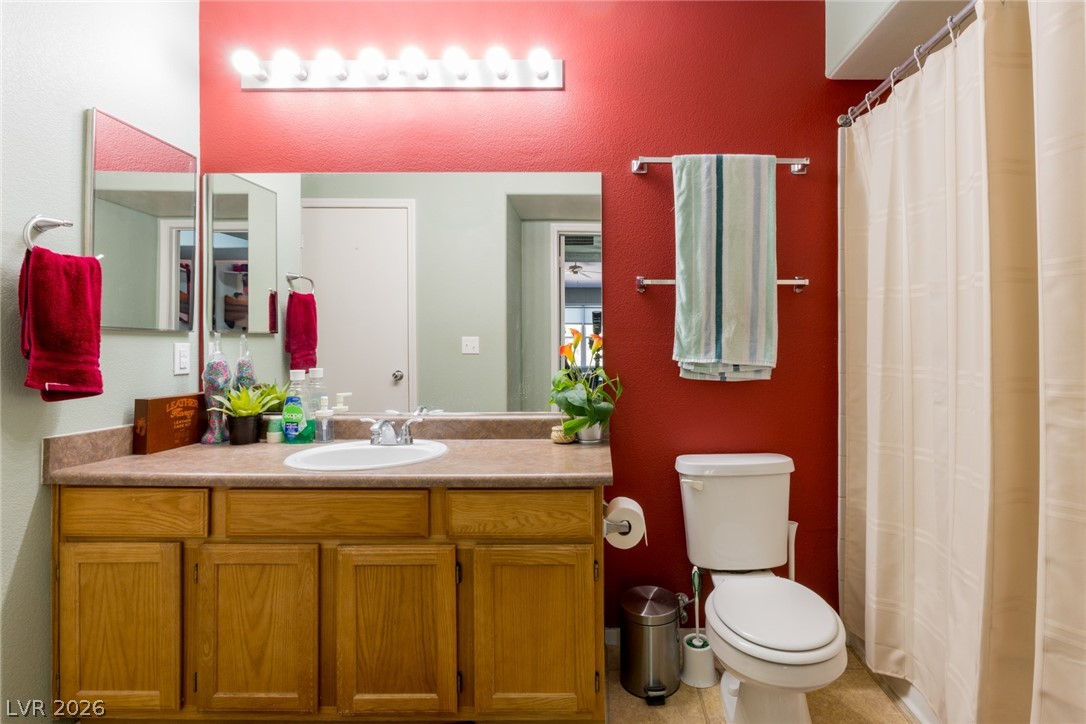 7255 West Sunset Road, Unit 2030 Las Vegas, NV 89113 - Photo 14 of 24 Full bathroom with vanity, a shower with curtain, and a textured wall