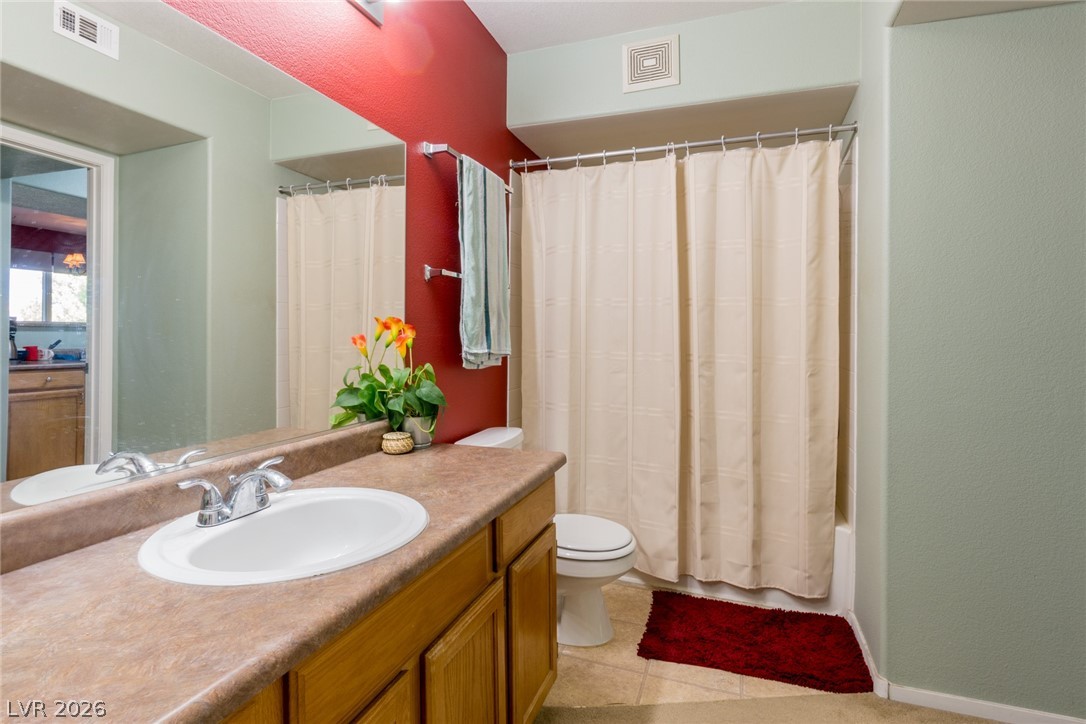 7255 West Sunset Road, Unit 2030 Las Vegas, NV 89113 - Photo 15 of 24 Full bath featuring vanity, light tile patterned floors, and shower / bath combo